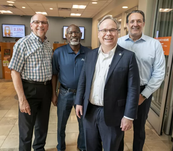 (Pictured left to right): Amplify CEO Paul Trylko, Amplify Board Chairman Willie Everett, NCUA Board Member Todd Harper and incoming Amplify Executive Vice President Kendall Garrison.