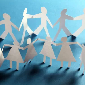 Paper cutouts of people stand together